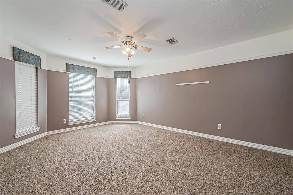 Upstairs bedroom #2 has ample of square footage with floor to ceiling windows for natural light.