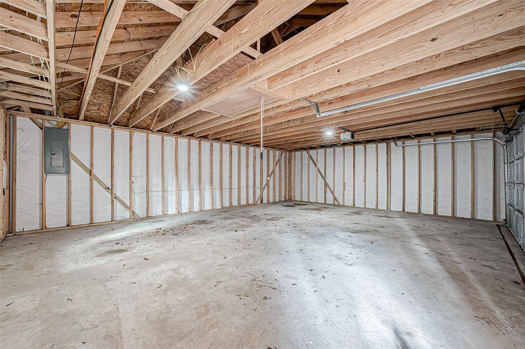 The spacious garage offers plenty of room for vehicles, storage, or a workshop—perfect for car enthusiasts or those in need of extra space.