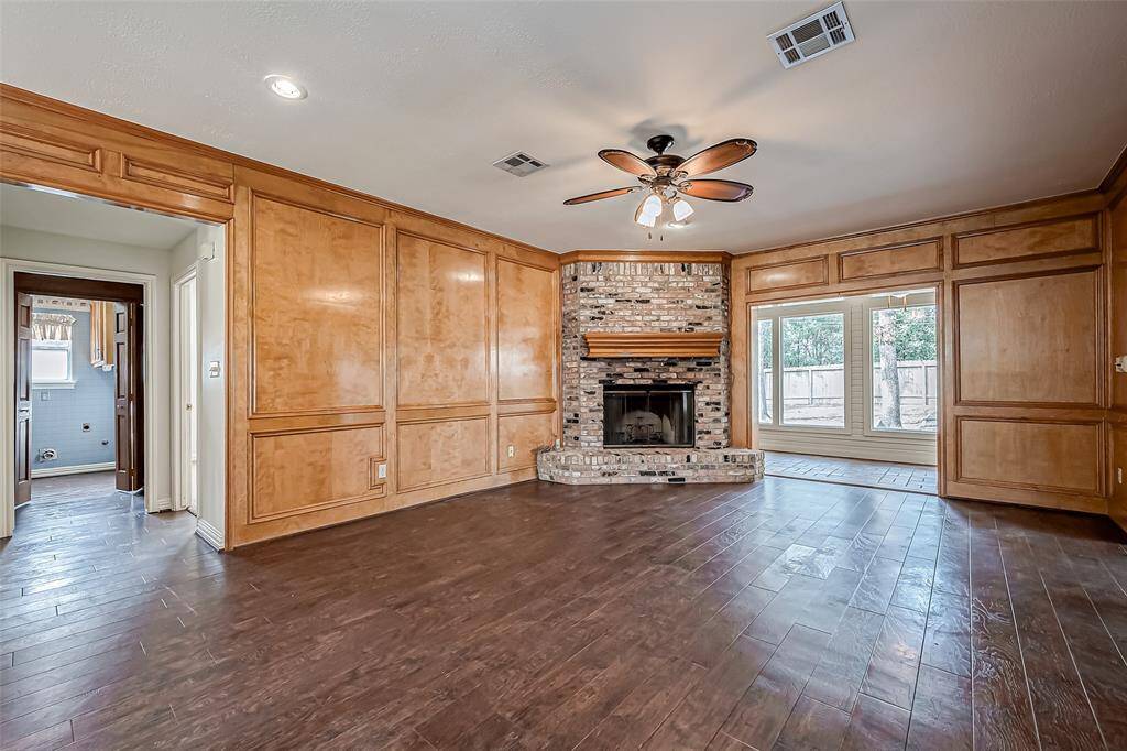 The extra-large family room is the perfect gathering space, with a stunning fireplace serving as its focal point.