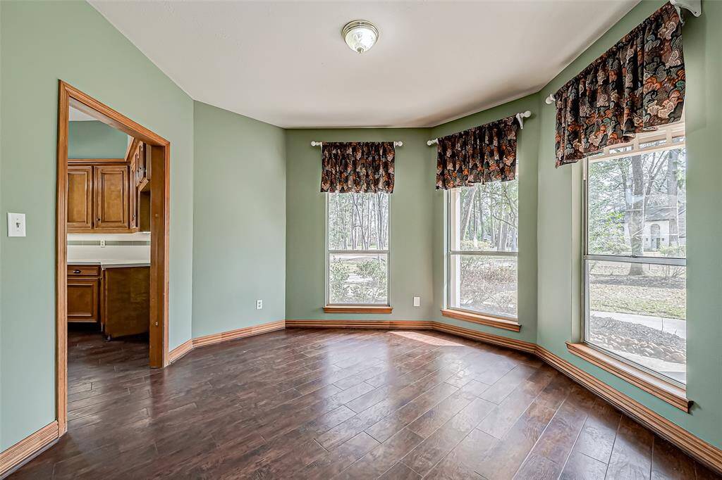 Just off the kitchen, the formal dining room features beautiful windows that fill the space with natural light.