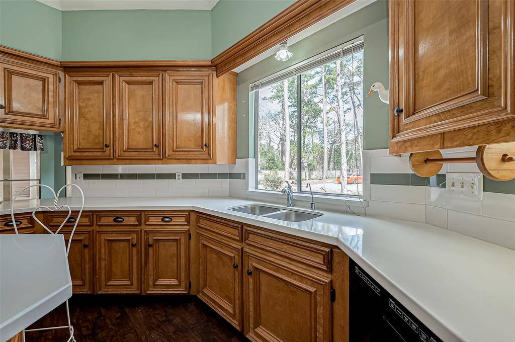 A large window above the sink brings in plenty of natural light, creating a warm and inviting atmosphere while you prep meals or do the dishes.