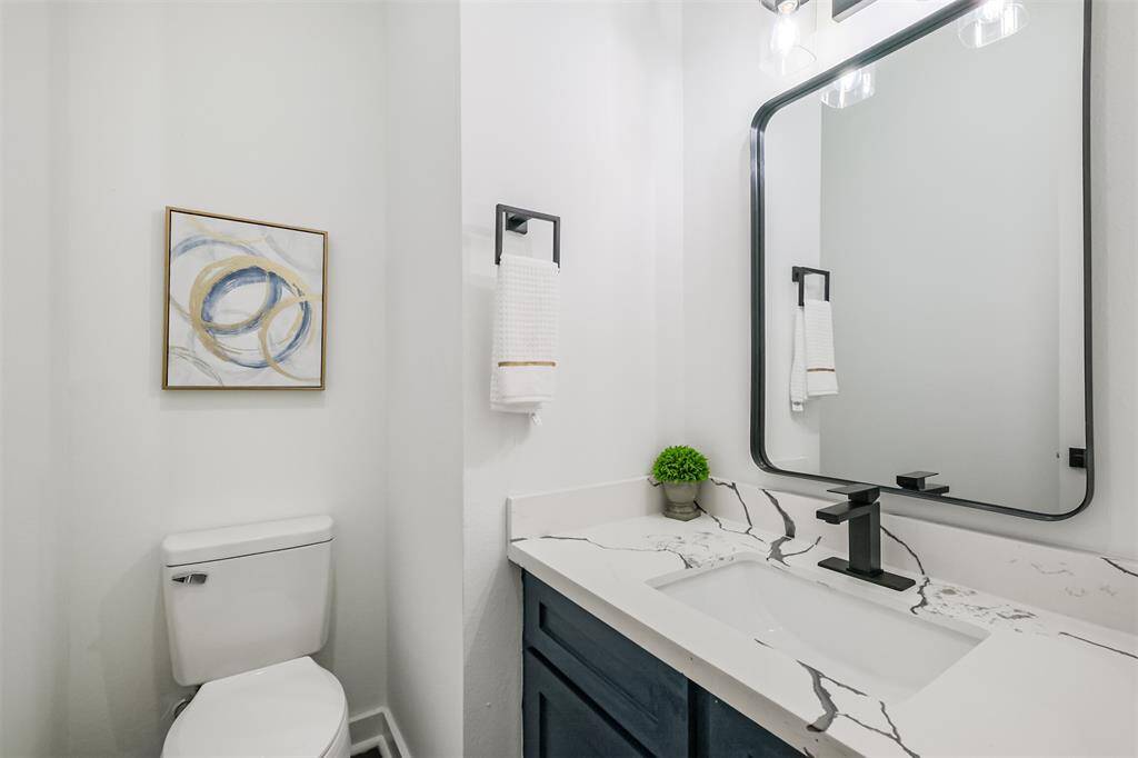 This photo shows a bright, modern room with white walls and dark hardwood flooring. It features a double-door closet and a simple overhead light fixture. Natural light streams in, creating a welcoming atmosphere.