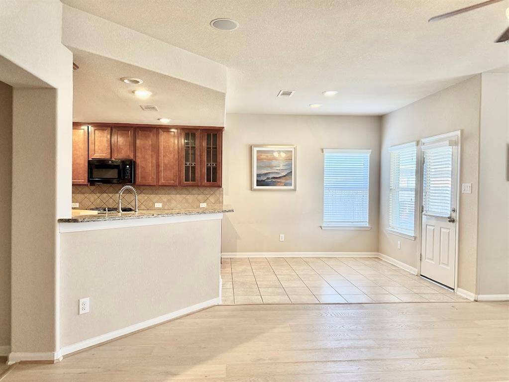 Featuring an open floor plan, the living and breakfast area boasts ample natural light, perfect for family gatherings.