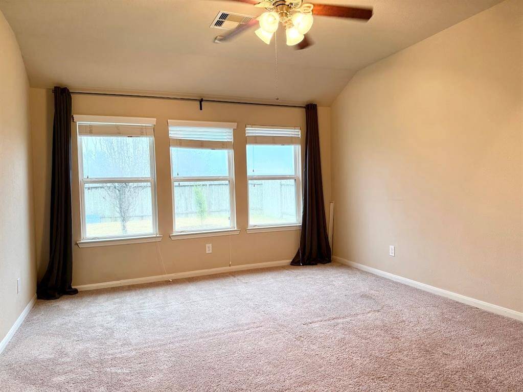 Master bedroom downstairs with walk-in closet and an en-suite bathroom offering soaking tub and separate shower