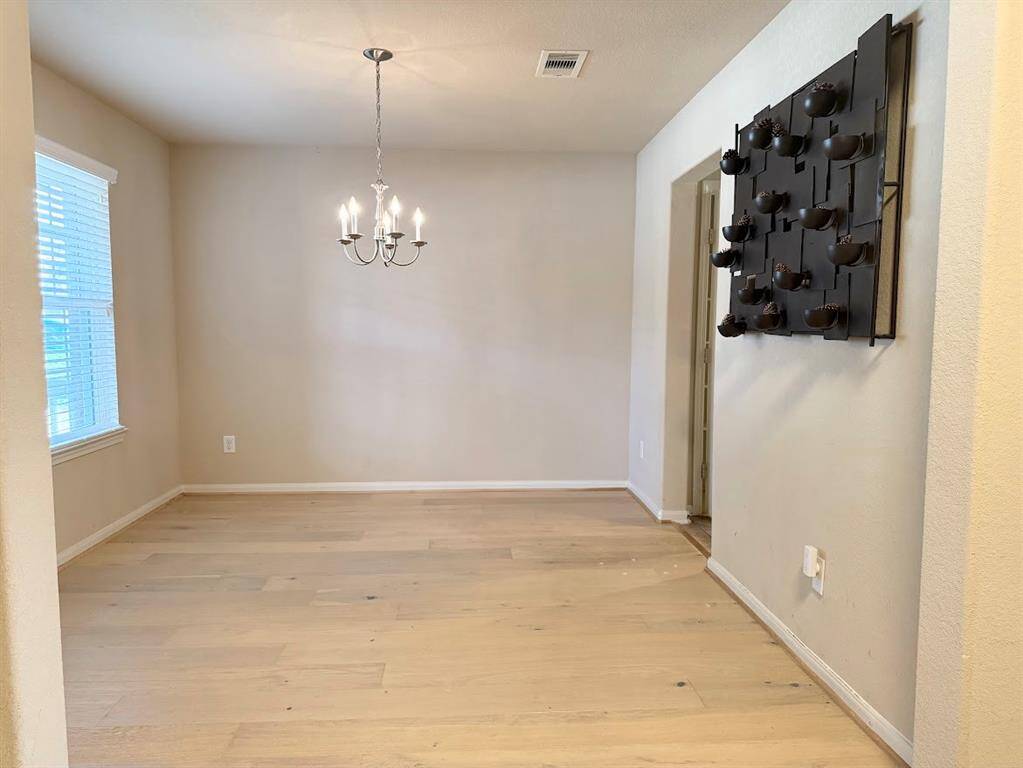 Elegant dining space adjacent to kitchen, suitable for hosting dinner parties