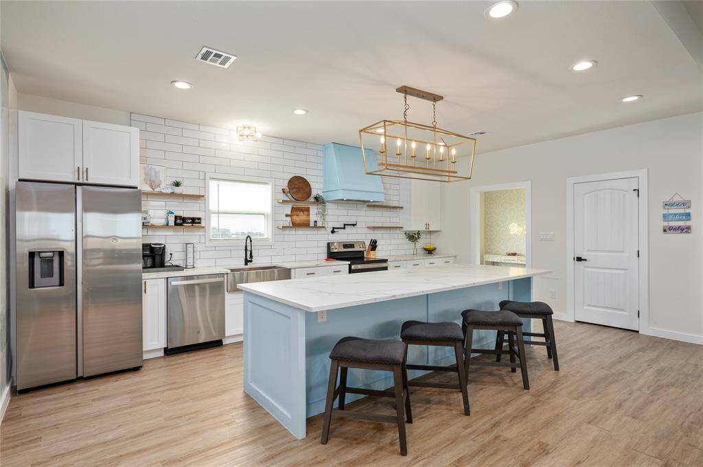 The kitchen is conveniently located near the back entrance, mud room, and the laundry room.