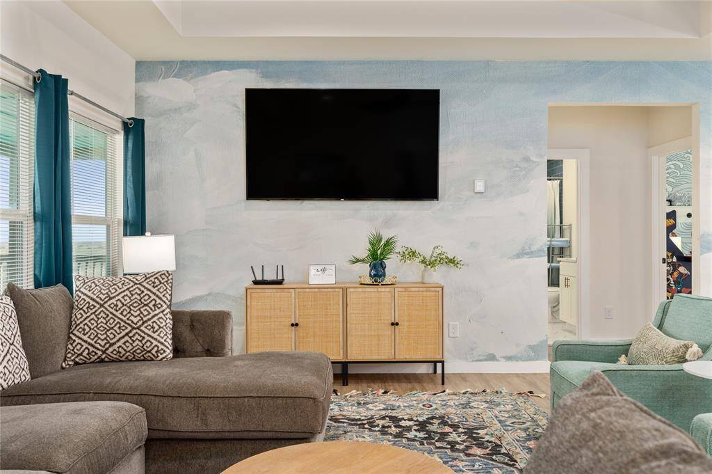 The wall mural extends into the living room