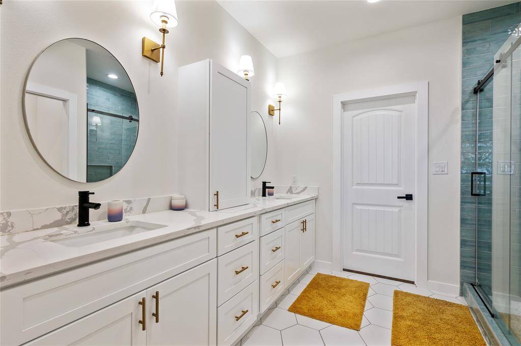 Primary bathroom is an absolute treat with double vanity, plenty of storage, and tile flooring.