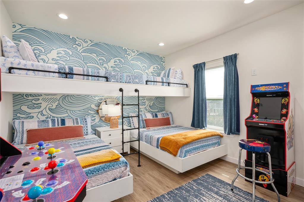 Between the built-in beds, arcade games, and TV, this third bedroom is a kid paradise!