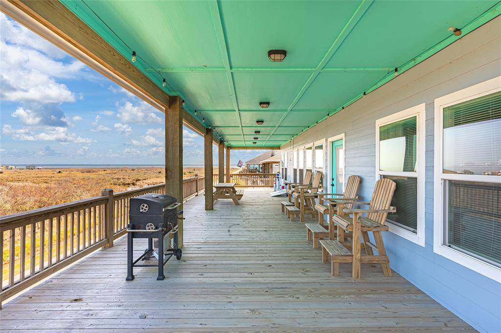The front deck looks out across a large, undeveloped tract of land providing a peaceful view of the Gulf