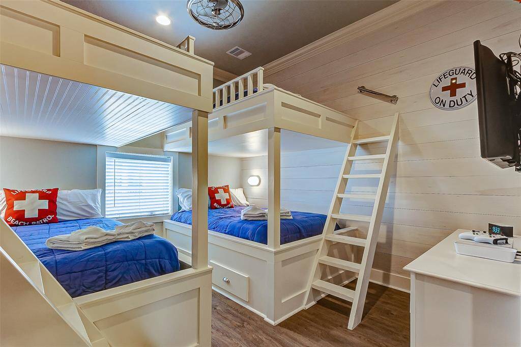 The third bedroom has 2 set of custom, built-in full-over-full bunk beds with easy-to-access top bunks.  The shiplap wall adds an extra touch of style while adding durability. The caged fan allows for airflow while maintaining safety.