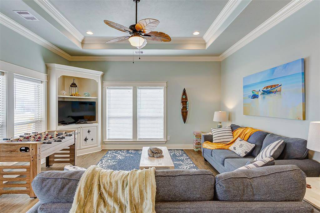 Spacious living room has plenty of seating and even has a foosball table for added entertainment