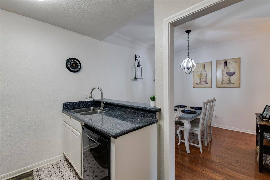 Updated kitchen with granite countertop, built-in microwave, dishwasher (2021) and spacious pantry.