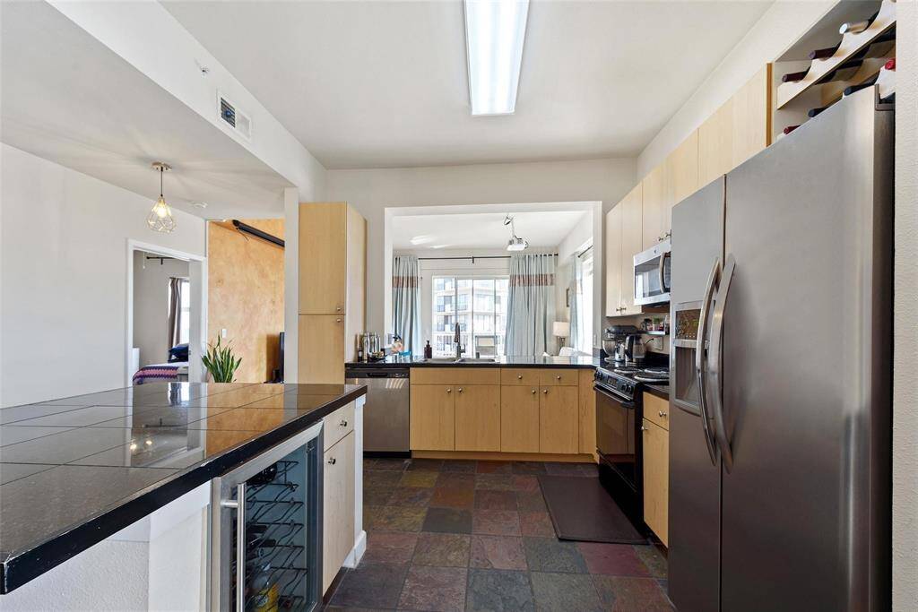 dditional storage for wine above the refrigerator make this a terrific kitchen to entertain.