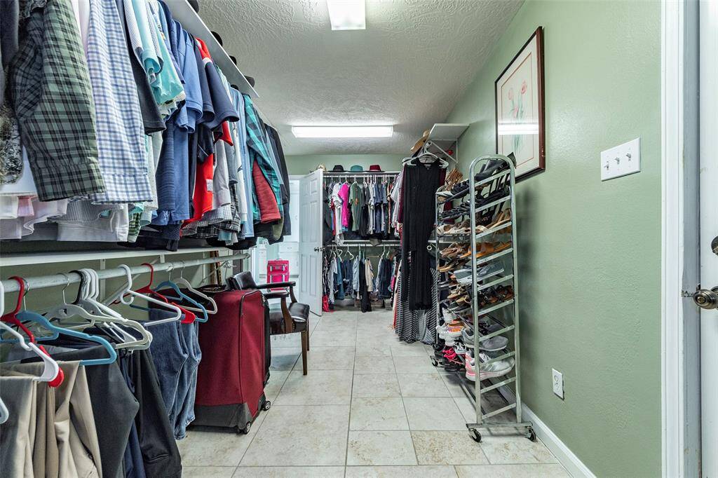This closet is amazing with built-in drawer/cabinet and room for all your clothes and then some.