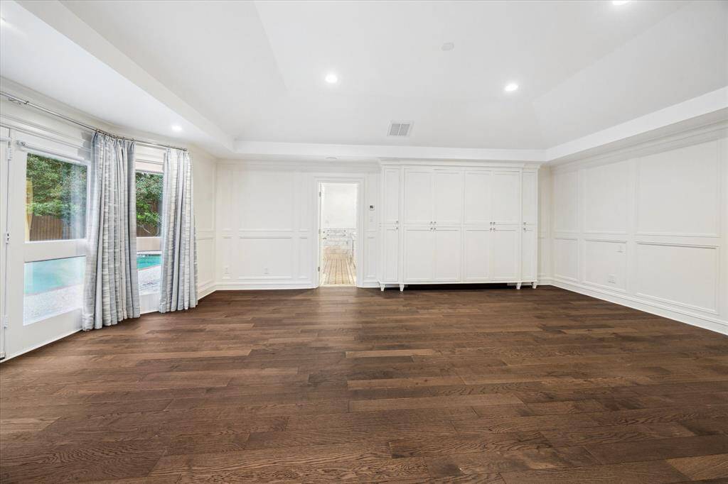 [Primary Bedroom] Owner's suite is a true retreat with hardwood floors and custom built-ins.