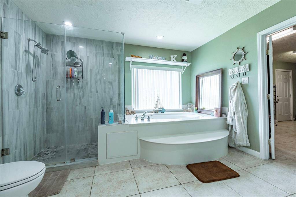 Relax in the garden tub that is separate from the walk-in, glass surround shower.