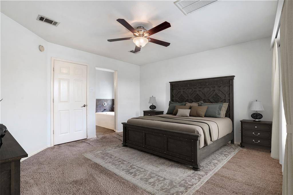 The master bedroom boasts and ensuite bath with a double vanity, walk-in closet, garden tub, and shower.