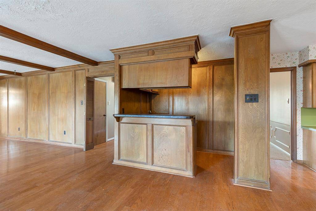The family room has a wall of windows and a wood-burning fireplace with a brick surround. *This image has been virtually staged.