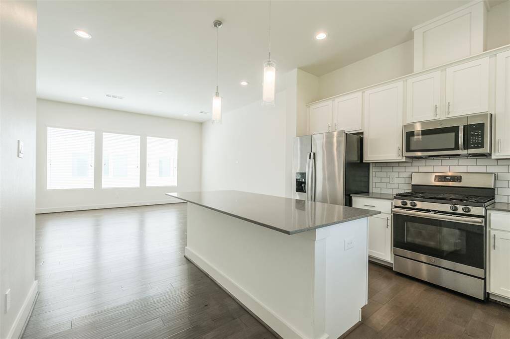 Indulge in the luxury of a spacious kitchen complete with a large island, perfectly suited for gathering around with barstools for a casual evening of cocktails or a cozy breakfast. This inviting space is designed for both functionality and entertainment.