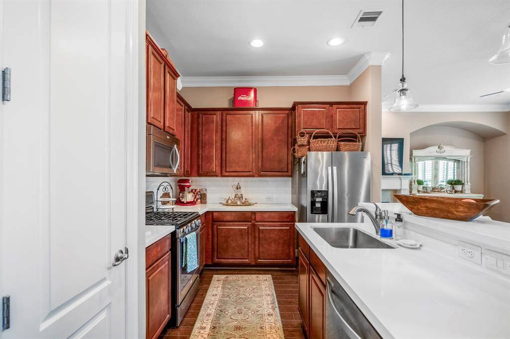 The galley style kitchen has plenty of countertop space for food preparation and serving.