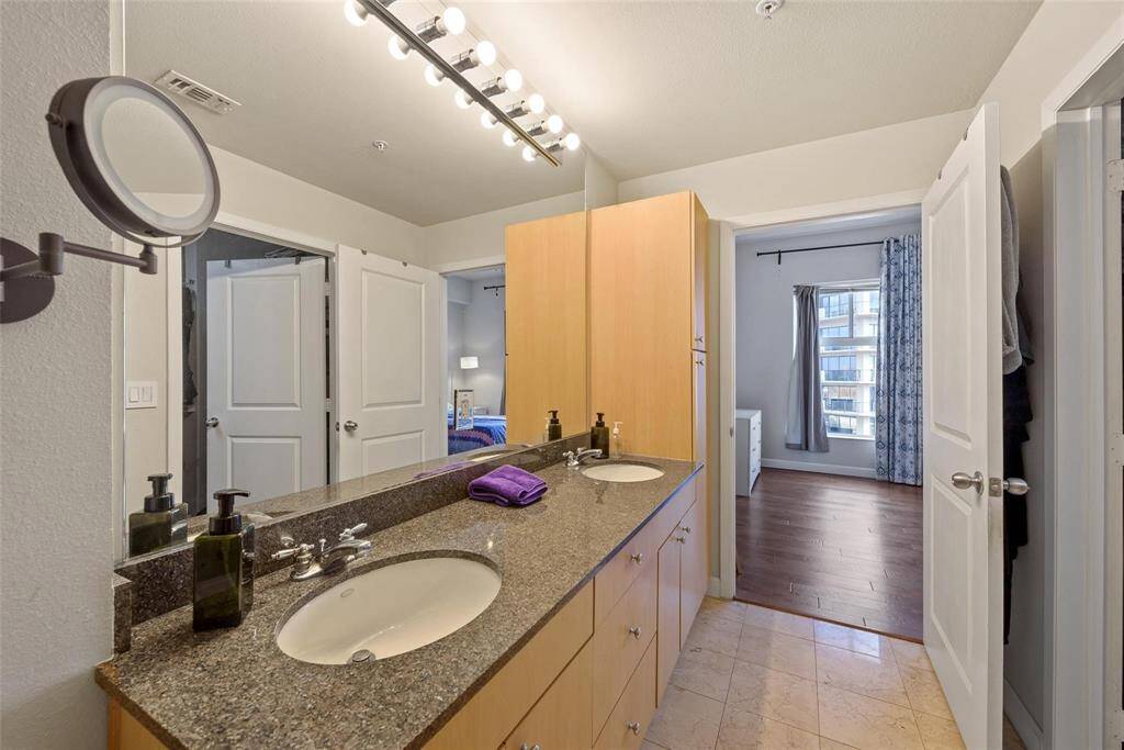 The spacious primary bathroom with has two sinks, a shower and a soaking tub.