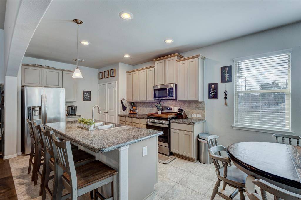 Breakfast bar provides four seats.  The pantry is neatly located in the corner of the kitchen.