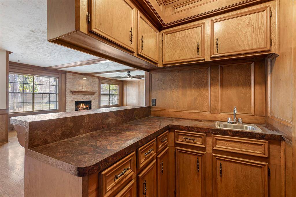The family room offers a wet bar with wood paneling.