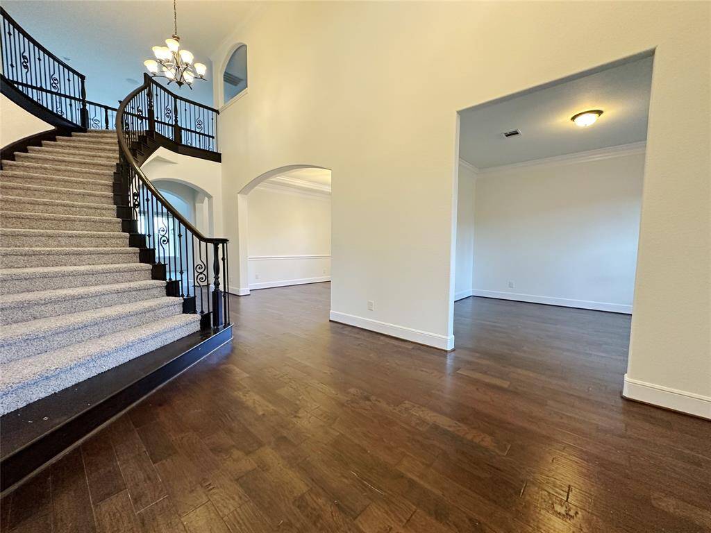 Elegant entryway with winding  stairs leading to the second floor