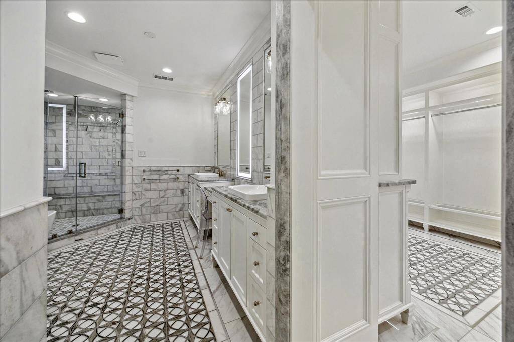 [Primary Bathroom] Has marble counters, dual sinks, frameless walk-in shower with bench. Expansive closet.