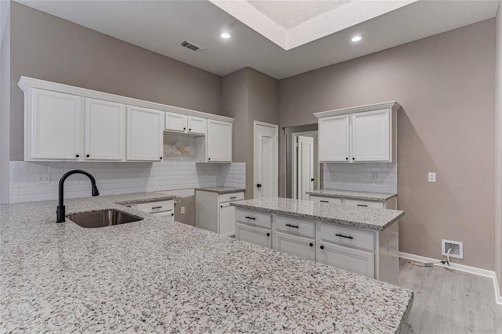 Stunning remodeled kitchen with modern finishes and ample counter space.