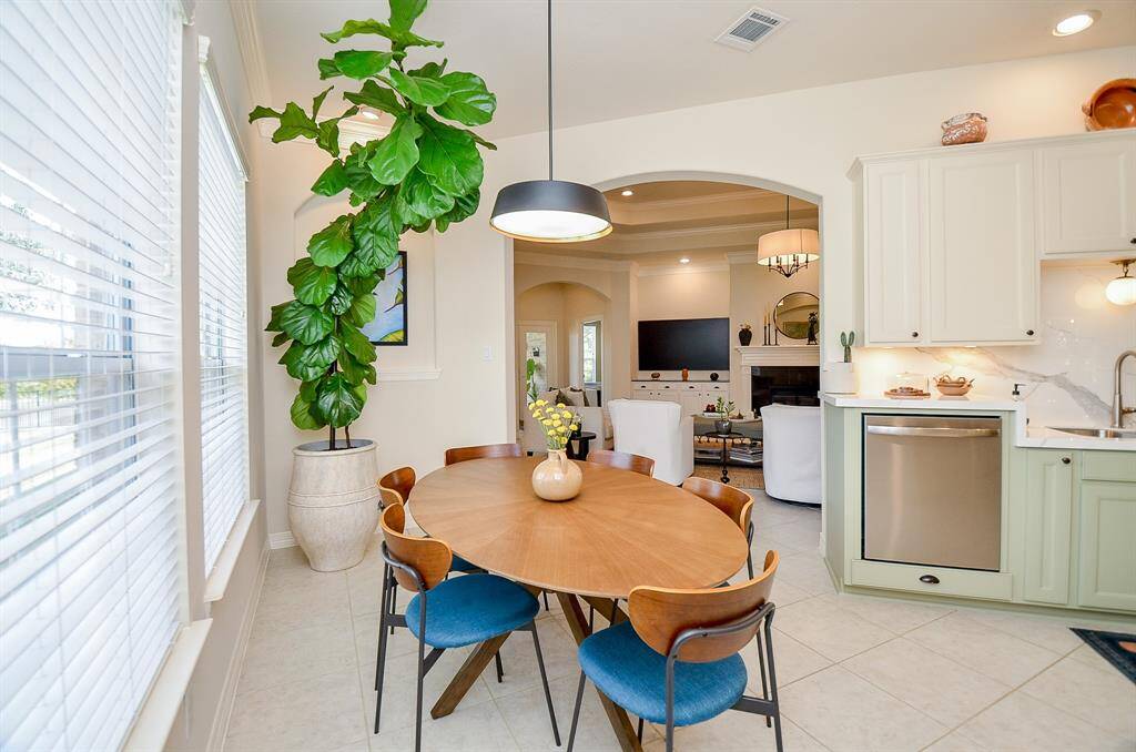 You will love having breakfast in this informal dining area.  This is such a warm and happy setting with the natural light.  Bonus: this gorgeous plant conveys with the property!