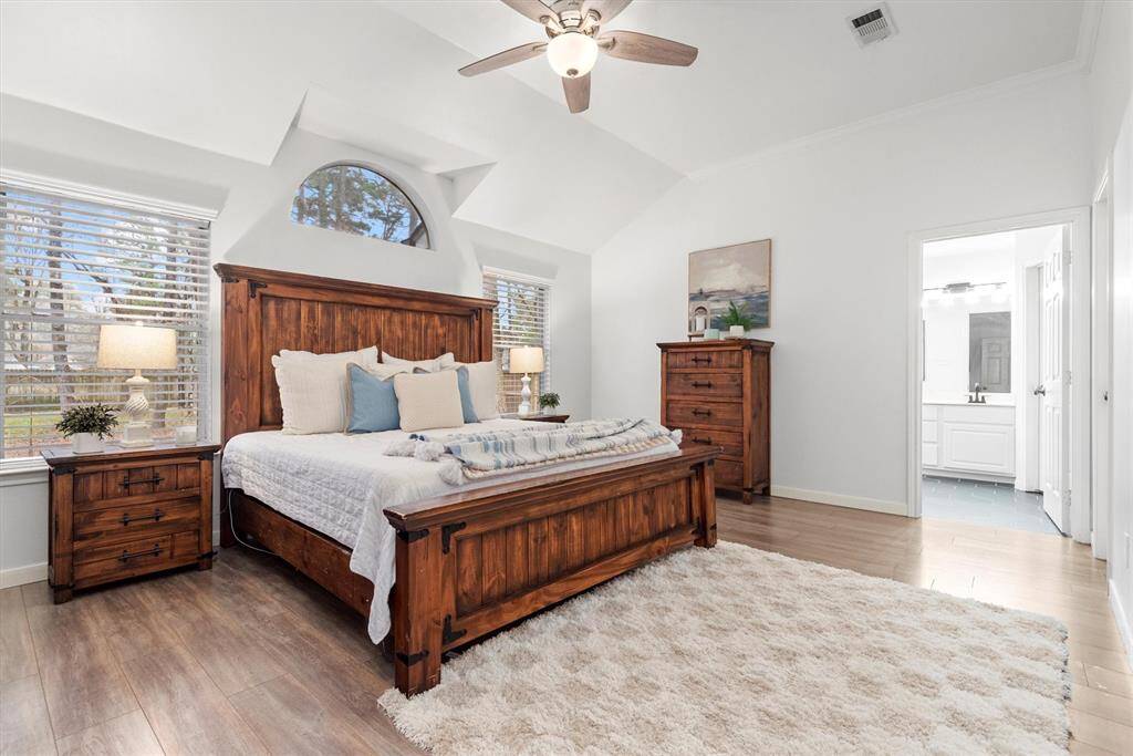 The spacious primary bedroom is 17 by 13 feet.  This king sized bed, dresser, chest and 2 nightstands easily fit with room to spare.