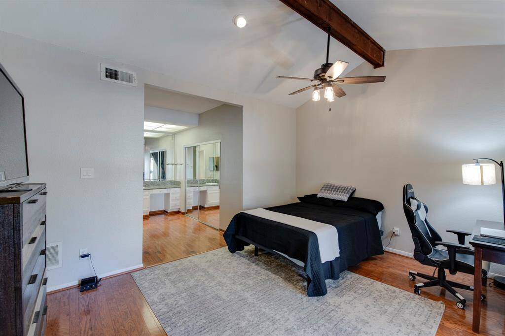 Primary bath has granite vanity with porcelain sink and closet to the right with slighting mirrored doors.