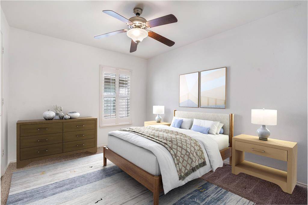 Bedroom #2 features plantation shutters, a ceiling fan, and high ceilings.