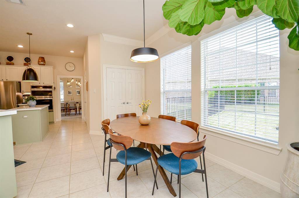 Another view of the dining area and the lovely plant.  Double door pantry with automatic lights is on the far wall.
