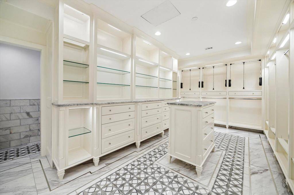 [Primary Closet] Exceptional walk-in closet with custom-made shelving and drawers, every shoe, purse, and blazer has its proper place.