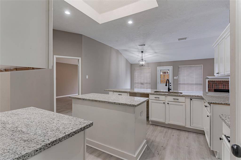 Sleek, modern kitchen with a skylight directly above to let in lots of natural light.