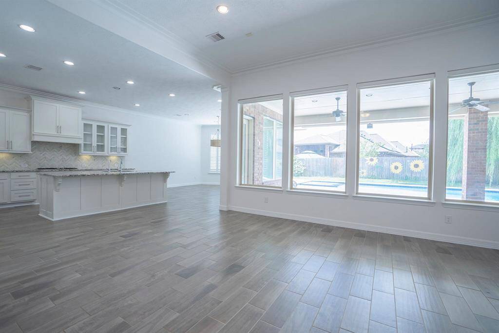 Living room open to kitchen with views of the pool