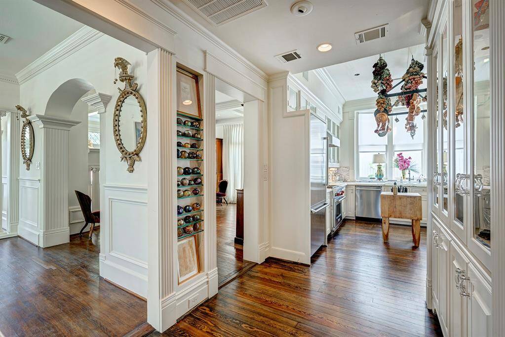 The dining room and living room flow seamlessly into the kitchen. Together, these interconnected spaces create a warm and inviting atmosphere, effortlessly combining functionality with an ideal layout for hosting memorable occasions.