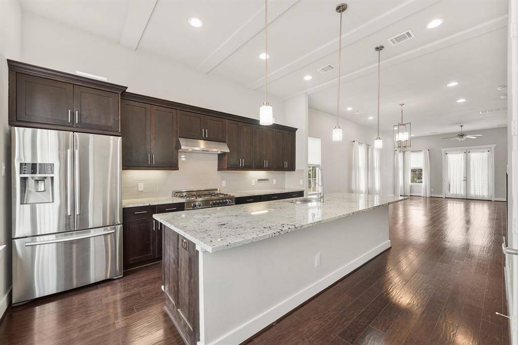 The stainless steel appliance package includes an upgraded Bertazzoni 5-burner gas range with conventional oven below, stainless steel vent hood with lighting, a built-in microwave oven & dishwasher. As an added bonus, the stainless steel French door refrigerator with door mounted ice & water dispenser along with a separate beverage/wine fridge stays with the home.