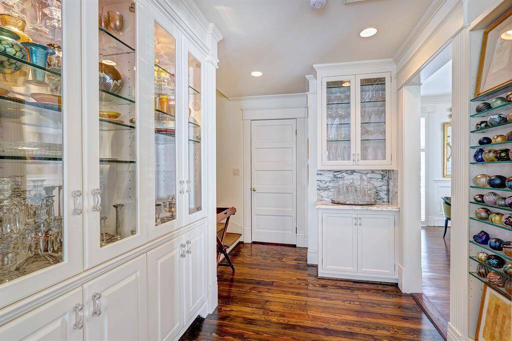 Just off the kitchen, this thoughtfully designed space offers an abundance of custom-built cabinetry, providing the perfect solution for organizing and showcasing your fine china and entertaining essentials.