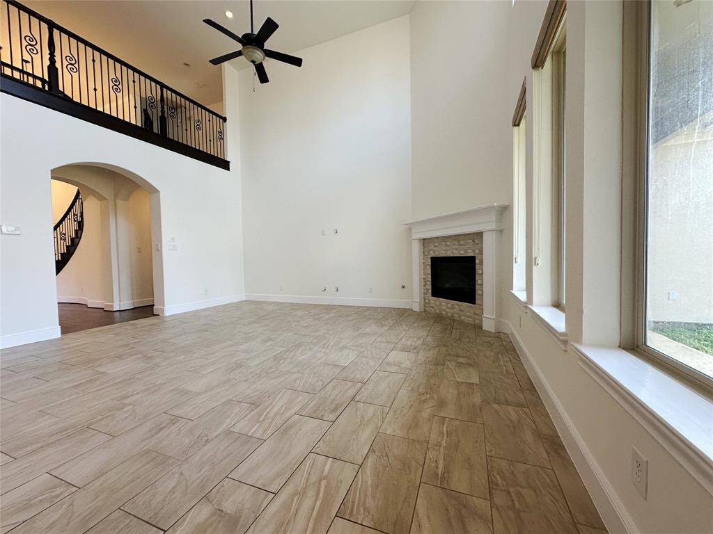 High ceiling living room area view of backyard