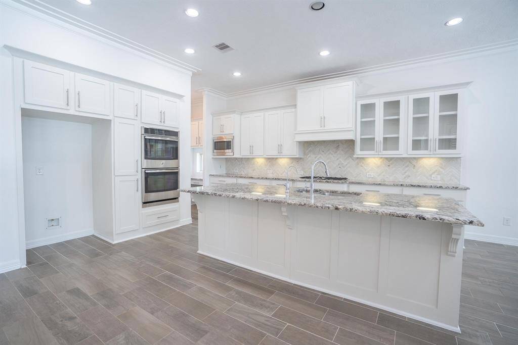 Elegant kitchen with huge island and SS appliances
