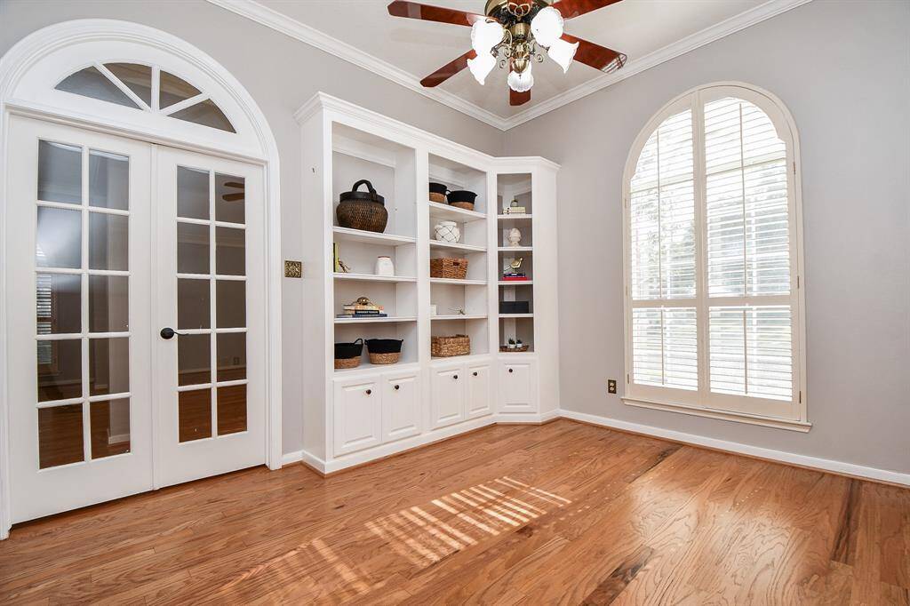 Beautiful built-in bookshelves, large window with shutters and French doors in front room.