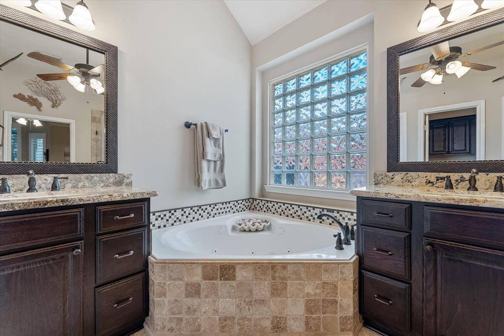 Deep soak whirlpool tub with glass block window above for privacy