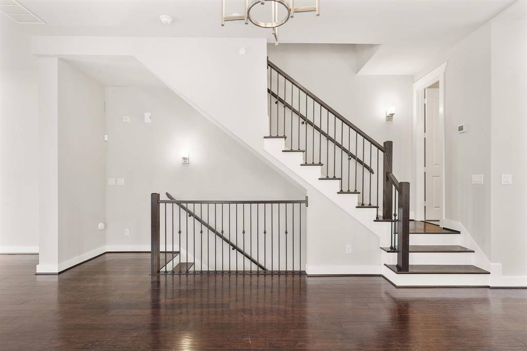 A view of the staircase from the dining room with the half bath shown on the right.