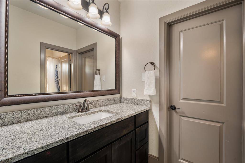 The home office boasts warm wood floors and elegant crown molding that add a touch of sophistication. Glass French doors at the entry allow natural light to flow in, creating an open and inviting atmosphere.