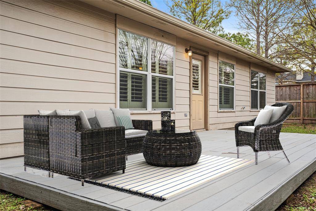 The small easy-care backyard  offers a quiet deck.