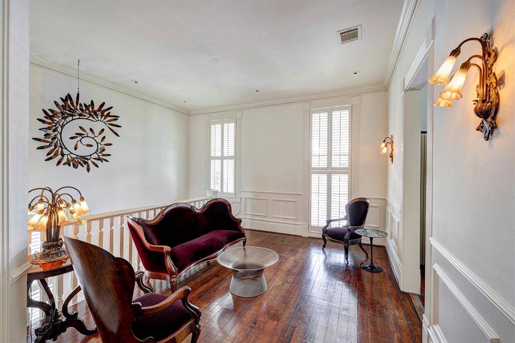 The upstairs landing, situated just off the main staircase, is a bright and inviting space bathed in natural light.